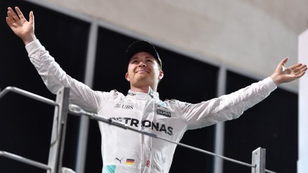 Mercedes AMG Petronas F1 Team's German driver Nico Rosberg celebrates at the end of the Abu Dhabi Formula One Grand Prix at the Yas Marina circuit on November 27, 2016. Nico Rosberg won his maiden F1 world title by securing second place behind his Mercedes arch-rival Lewis Hamilton. Andrej ISAKOVIC / AFP