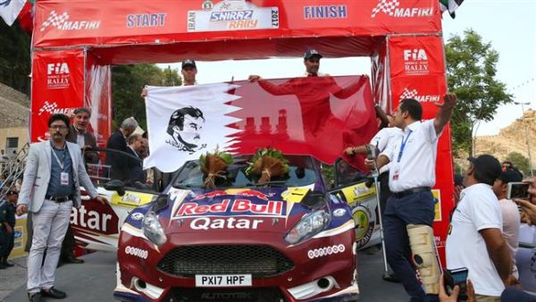 Qatari rally driver Nasser Salih Nasser Abdullah al-Attiyah (R) and French co-driver Matthiew Baumel pose for a photograph after finishing first at Iran International Rally, south-central Iran, on September 15, 2017. (Photo: Press TV)