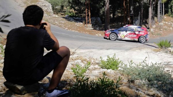 A fan watches as Qatar's Nasser Al-Attiyah and Mathieu Baumel take part in the Rally of Lebanon near the northern Lebanese village of Sourat on August 26, 2017.
IBRAHIM CHALHOUB / AFP