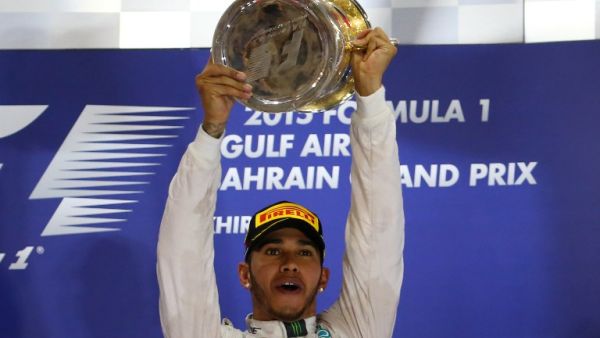 Mercedes AMG Petronas British driver Lewis Hamilton celebrates with his trophy on the podium after winning the Formula One Bahrain Grand Prix at the Sakhir circuit in the desert south of the Bahraini capital, Manama, on April 19, 2015. AFP PHOTO / MARWAN NAAMANI
MARWAN NAAMANI / AFP