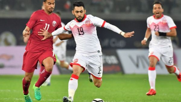 Qatar's Akram Afif (L) vies for the ball with Bahrain's Kamil al-Aswad (R) during the 2017 Gulf Cup of Nations football match between Qatar and Bahrain at the Sheikh Jaber al-Ahmad Stadium in Kuwait City on December 29, 2017.

GIUSEPPE CACACE / AFP