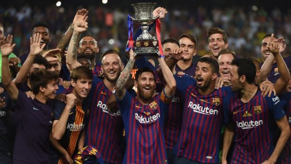 Barcelona's Argentinian forward Lionel Messi (C) carries the cup as they celebrate at the end of the Spanish Super Cup final between Sevilla FC and FC Barcelona at Ibn Batouta Stadium in the Moroccan city of Tangiers on August 12, 2018.
FADEL SENNA / AFP