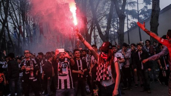 Besiktas supporters cheer their team before the Turkish Spor Toto Super league football match between Besiktas and Bursaspor at vodafone arena stadium on April 11, 2016 in Istanbul. Besiktas football team plays its first game at the new vodafone Arena stadium after its inauguration on April 10.
YASIN AKGUL / AFP