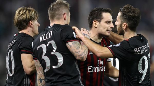AC Milan's Giacomo Bonaventura (2nd from right) celebrates with teammates scoring a goal against Juventus' team during the Italian Super Cup final match between AC Milan and Juventus in Doha on December 23, 2016.
KARIM JAAFAR / AFP