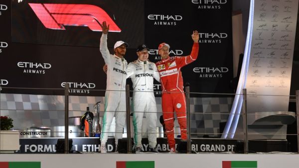(From L to R) Mercedes' British driver Lewis Hamilton, Mercedes' Finnish driver Valtteri Bottas and Ferrari's German driver Sebastian Vettel celebrate on the podium at the end of the Abu Dhabi Formula One Grand Prix at the Yas Marina circuit on November 26, 2017. Bottas won the season-ending Abu Dhabi Grand Prix on Sunday, finishing ahead of world champion Lewis Hamilton with Sebastian Vettel taking third.
Andrej ISAKOVIC / AFP