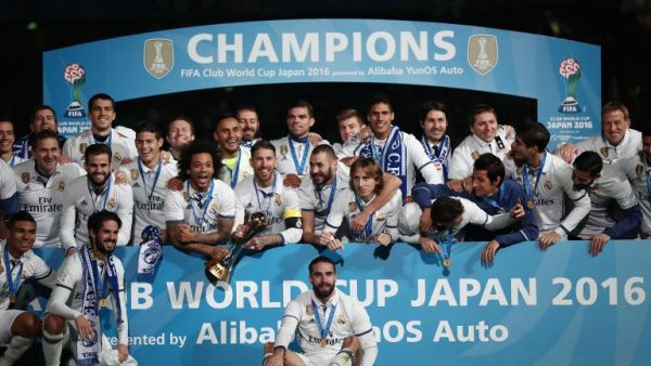 Real Madrid players pose with their trophy after winning the Club World Cup football final match against Kashima Antlers of Japan at Yokohama International stadium in Yokohama on December 18, 2016.
Behrouz MEHRI / AFP