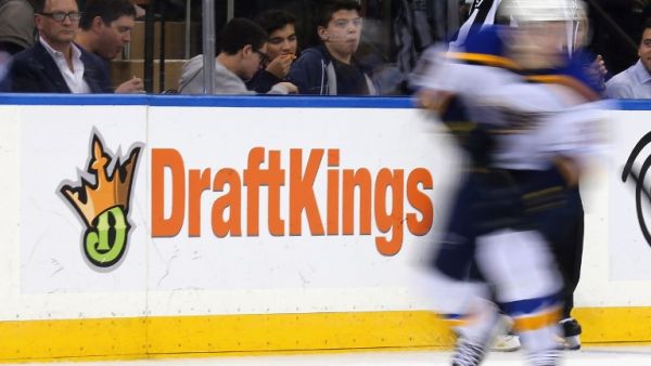 The New York Rangers and St. Louis Blues skate in front of a dasher board advertising the betting website DraftKings at Madison Square Garden on November 12, 2015 in New York City. Bruce Bennett/Getty Images/AFP
BRUCE BENNETT / GETTY IMAGES NORTH AMERICA / AFP