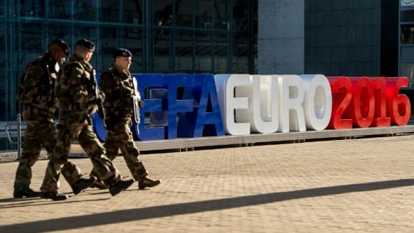 Soldiers walk past giant letters reading "UEFA EURO 2016" as they patrol on February 3, 2016, in Lille, northern France, where some of the Euro 2016 football matches will take place. The upcoming UEFA Euro 2016 European football championship will take place in France from June 10 to July 10, 2016.
PHILIPPE HUGUEN / AFP