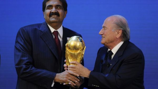 Emir of the State of Qatar Sheikh Hamad bin Khalifa Al-Thani (L) receives the World Cup trophy from Fifa President Joseph Blatter (R) after the official announcement that Qatar will host the 2022 World Cup on December 2, 2010 at the FIFA headquarters in Zurich. AFP PHOTO / PHILIPPE DESMAZES
PHILIPPE DESMAZES / AFP