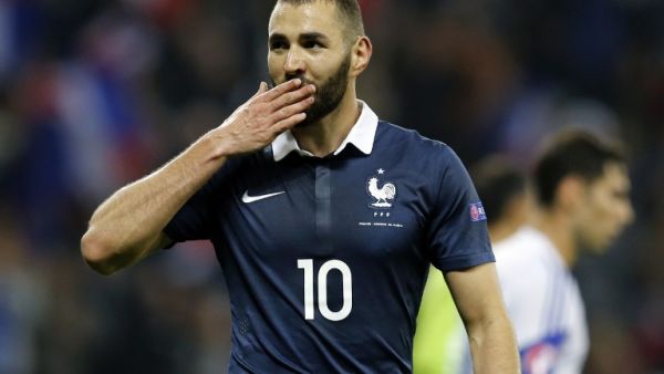(FILES) This file photo taken on October 09, 2015 shows French forward Karim Benzema celebrating after scoring a goal during the friendly football match between France and Armenia on October 8, 2015. The judicial review of Karim Benzema, indicted in the sex-tape blackmailing affair against Mathieu Valbuena, was lifted on March 11, 2016, by the Versailles Court of Appeal, opening the way to its come-back in the French national team for Euro 2016.