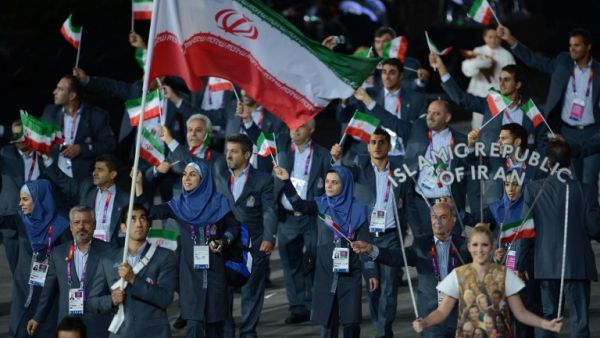 Iran's flagbearer Ali Mazaheri leads his delegation during the opening ceremony of the London 2012 Olympic Games in the Olympic Stadium in London on July 27, 2012. AFP PHOTO / CHRISTOPHE SIMON
CHRISTOPHE SIMON / AFP