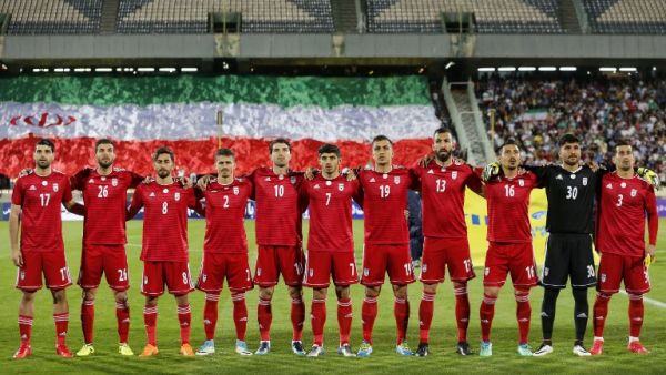 Iran's starting eleven line-up for their national anthem ahead of their international friendly match against Uzbekistan at Tehran's Azadi Stadium on May 19, 2018.
ATTA KENARE / AFP