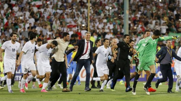 Portuguese coach Carlos Queiroz (C) of the Iranian national football team celebrates among players after winning the 2018 World Cup qualifying football match between Iran and Uzbekistan at the Azadi Stadium in Tehran on June 12, 2017. Iran won 2-0.
ATTA KENARE / AFP