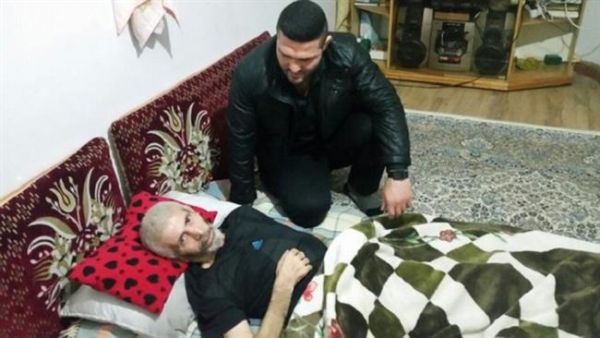 Late Iranian wrestler Nasser Hosseinpour rests as Iranian wrestler and two-time World Champion Reza Yazdani visits him at his house in the city of Juybar, northern Iran, in this undated picture. (Photo: Press TV)