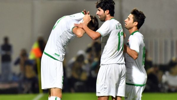 Iraq's defender Ali Faez (L) celebrates with his teammates after scoring a goal against Qatar during their 2017 Gulf Cup of Nations group match at Al Kuwait Sports Club Stadium in Kuwait City on December 26, 2017.
GIUSEPPE CACACE / AFP