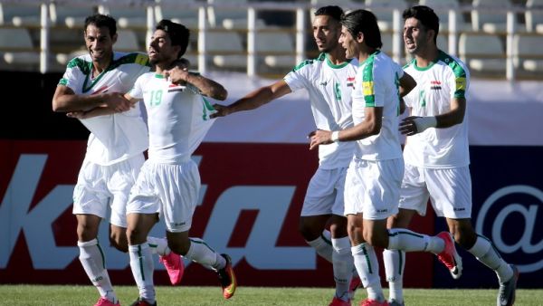Iraqi players celebrate scoring a goal against Japan's team during their 2018 World Cup qualifying football match between Japan and Iraq at the Dastgherdi Stadium in the Iranian capital Tehran on June 13, 2017.
ATTA KENARE / AFP