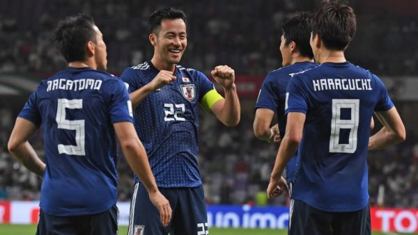 Japan's midfielder Genki Haraguchi (R) is congratulated for his goal during the 2019 AFC Asian Cup semi-final football match between Iran and Japan at the Hazza Bin Zayed Stadium in Abu Dhabi on January 28, 2019.
Roslan RAHMAN / AFP