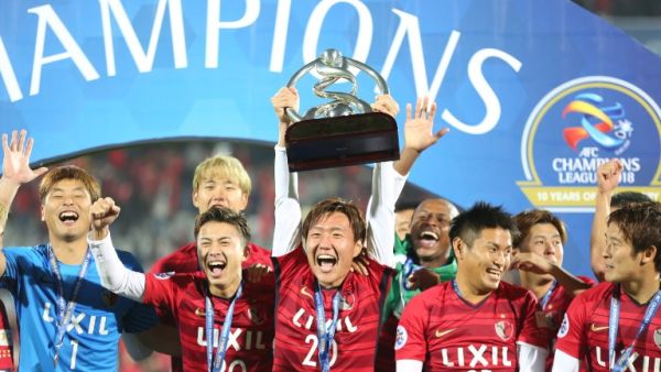Kashima Antler's midfielder Kento Misao holds the trophy as he celebrates with his teammates after winning the AFC Champions League final football match between Iran's Persepolis and Japan's Kashima Antlers on November 10, 2018, at the Azadi Stadium in Tehran.
ATTA KENARE / AFP