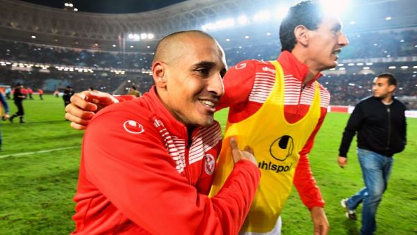 Tunisian footballers Wahbi Khazri (C-L) and Karim Awadhi (C-R) celebrate on the pitch after qualifying for the 2018 World Cup finals after drawing their qualifiers match against Libya at the Rades Olympic Stadium in the capital Tunis on November 11, 2017.
FETHI BELAID / AFP