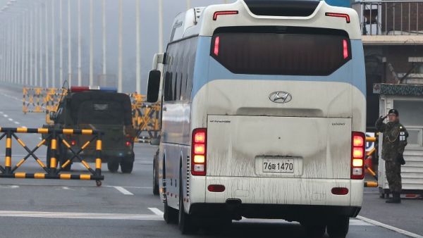A bus carrying a delegation of South Korean officials passes a military check point on the road leading to the border truce village of Panmunjom in Paju on January 15, 2018. North and South Korea began talks on January 15 on appearances by Pyongyang's state-run artistic performers at next month's Winter Olympics in the South, after the North agreed to attend the Games.

YONHAP / AFP