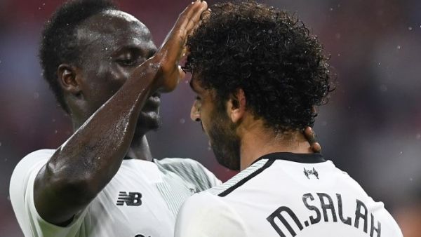 Liverpool's Senegalese striker Sadio Mane (L) and his teammate Liverpool's Egyptian striker Mohamed Salah (R) react after the second goal for Liverpool during the second Audi Cup football match between FC Bayern Munich and FC Liverpool in the stadium in Munich, southern Germany, on August 1, 2017.
Christof STACHE / AFP