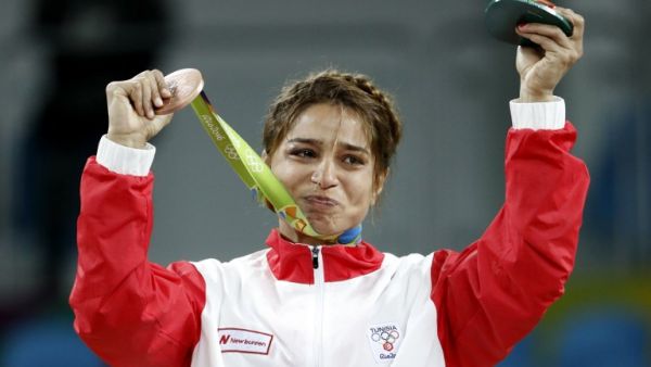 Tunisia's bronze medallist Marwa Amri reacts on the podium at the end of the women's 58kg freestyle wrestling event at the Carioca Arena 2 in Rio de Janeiro on August 17, 2016, during the Rio 2016 Olympic Games. Jack GUEZ / AFP