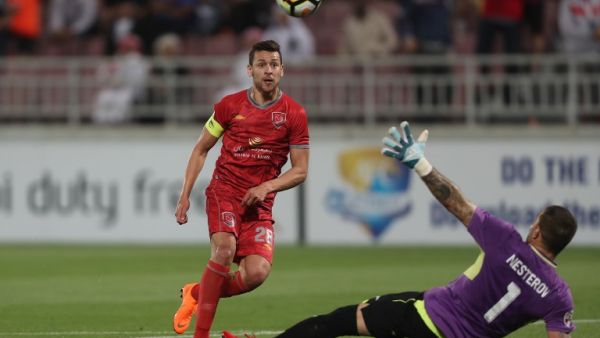 Al-Duhail's Youssef Msekni kicks the ball past Lokomotiv's goalkeeper Ignaty Nesterov during the AFC Champions League football match between Lokomotiv of Uzbekistan and al-Duhail of Qatar at the Abdullah bin khalifa stadium in Doha on March 6, 2018.
KARIM JAAFAR / AFP