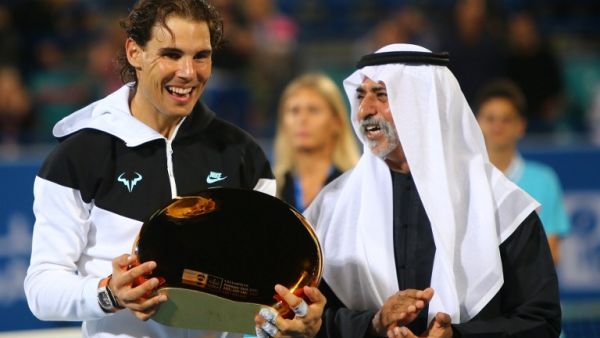 Spanish player Rafael Nadal (L) poses with his winning trophy next to UAE Sports and Youth Minister Sheikh Nahyan Bin Mubarak al-Nahyan after beating Canadian player Milos Raonic in the final match of the Mubadala World Tennis Championship in Abu Dhabi on January 2, 2016. AFP PHOTO / MARWAN NAAMANI
MARWAN NAAMANI / AFP