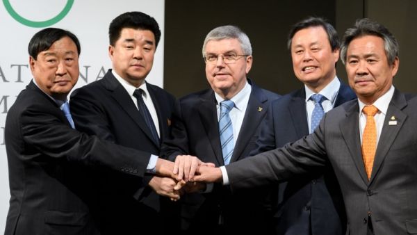 (From L) PyeongChang 2018 Olympics (POCOG) President Lee Hee-beom, North Korea's Sports Minister and Olympic Committee president Kim Il Guk, International Olympic Committee (IOC) President Thomas Bach, South Korean Minister of Culture, Sports and Tourism Do Jong-hwan and South Korea's National Olympic Committee President Lee Kee-heung join their hands as they pose during a signing ceremony at the Olympic Museum on January 20, 2018 in Lausanne. 
Fabrice COFFRINI / AFP