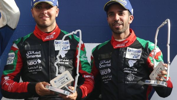 Oman Racing’s Ahmad Al Harthy, right, and Tom Jackson celebrate on the podium. Photo - Supplied 