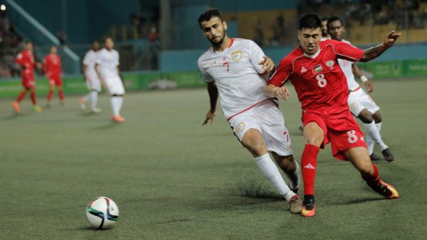 Palestine, in red, vs. Oman at Faisal Husseini Stadium near Jerusalem. Palestine won 2-1. (Photo: Palestinian Football Association)