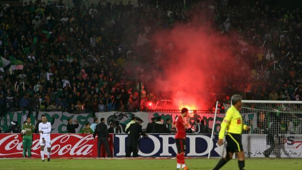 Egyptian fans of Al-Masry light flares during a football match against Al-Ahly in Port Said on February 1, 2012. At least 74 people were killed and hundreds injured when rival fans clashed after the football match, highlighting a security vacuum in post-revolution Egypt. AFP PHOTO/STR
STR / AFP