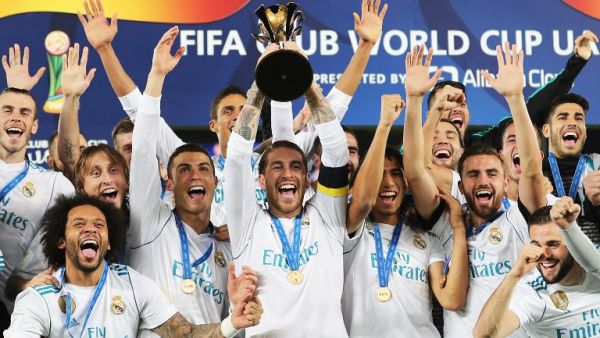 Real Madrid's players celebrate with the FIFA Club World Cup trophy following their victory in the final football match against Gremio FBPA at the Zayed Sports City Stadium in Abu Dhabi on December 16, 2017. Real Madrid defeated Gremio 1-0 to lift the FIFA Club World Cup for the third time in their history.
KARIM SAHIB / AFP