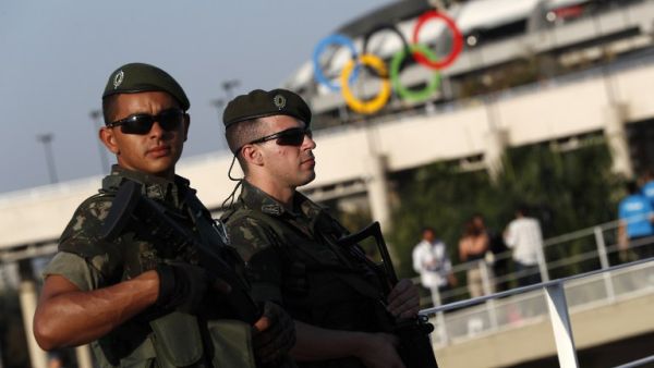 Brazilian security forces stand guard outside the Maracana stadium in Rio de Janeiro on August 5, 2016. A vast security blanket of 85,000 military personnel and police -- twice the number on duty at the 2012 London Games -- are draped over the city to ward off the threat of street crime and terror attacks.
Adrian DENNIS / AFP
