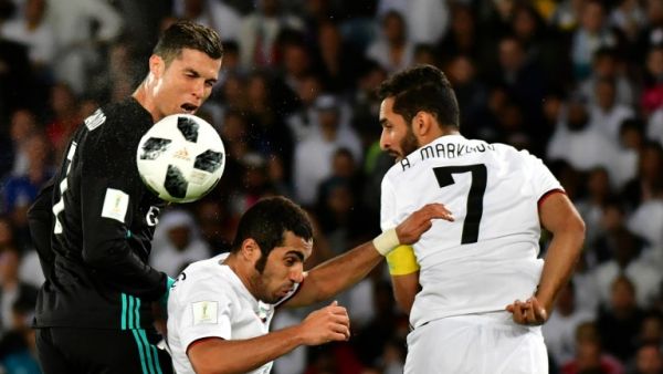 Real Madrid's Portuguese forward Cristiano Ronaldo (L) vies for the header with al-Jazira's Emirati defender Musallem Fayez (C) and Emirati forward Ali Mabkhout (R) during the FIFA Club World Cup semi-final match in the Emirati capital Abu Dhabi on December 13, 2017.
GIUSEPPE CACACE / AFP
