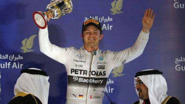 Mercedes AMG Petronas German driver Nico Rosberg holds up his trophy as he celebrates on the podium after taking third place in the Formula One Bahrain Grand Prix at the Sakhir circuit in the desert south of the Bahraini capital, Manama, on April 19, 2015. AFP PHOTO / MARWAN NAAMANI
MARWAN NAAMANI / AFP