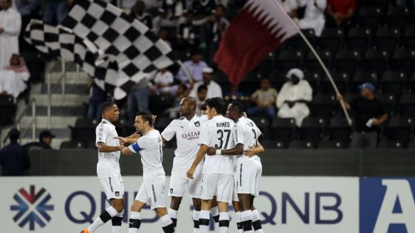 Al-Sadd's forward Baghdad Bounedjah is congratulated by his teammate after scoring during the AFC Champions League football match between Qatar's al-Sadd and UAE's al-Wasl at the Jassim bin Hamad Stadium in Doha, on April 2, 2018.
KARIM JAAFAR / AFP