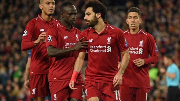 Liverpool's Egyptian midfielder Mohamed Salah (2nd R) celebrates with Liverpool's Senegalese striker Sadio Mane (2nd L) and Liverpool's Brazilian midfielder Fabinho (L) after scoring their third goal from the penalty spot during the UEFA Champions League group C football match between Liverpool and Red Star Belgrade at Anfield in Liverpool, north west England on October 24, 2018.
Oli SCARFF / AFP