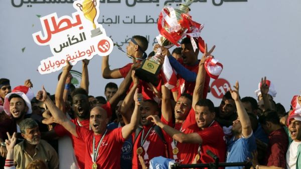 Players of Shabab Rafah football club celebrate their team's victory in the 2017 edition of the Gaza Cup at Yarmouk Stadium in Gaza City on May 12, 2017.
MAHMUD HAMS / AFP