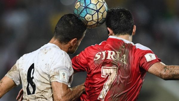 Omar Khrbin of Syria (R) and Morteza Pouraliganji of Iran head the ball during the 2018 World Cup qualifying football match between Syria and Iran at Tuanku Abdul Rahman Stadium in Seremban on November 15, 2016.
MOHD RASFAN / AFP