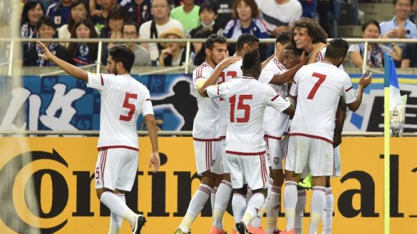 Players of United Arab Emirates (UAE) celebrate their winning goal against Japan during their football match in the final round of Asian qualifiers for the 2018 World Cup at Saitama Stadium on September 1, 2016. KAZUHIRO NOGI / AFP