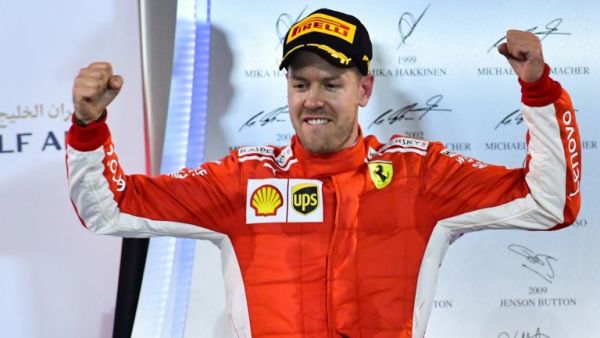 Ferrari's German driver Sebastian Vettel celebrates after winning the Bahrain Formula One Grand Prix at the Sakhir circuit in Manama on April 8, 2018.
GIUSEPPE CACACE / AFP
