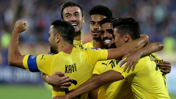 Al-Sadd's forward Baghdad Bounedjah (1st-R) celebrates after scoring a goal with his teammates, Spanish midfielders Xavi Hernandez (1st-L) and Gabi (2nd-L) during the AFC Champions League football match Al-Sadd (Qatar) vs Esteghlal FC (Iran) at the Azadi stadium in Tehran on August 27, 2018.
ATTA KENARE / AFP