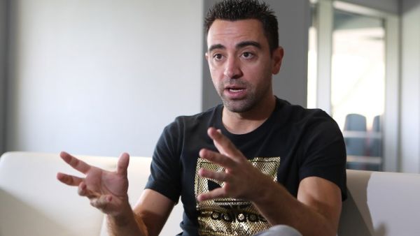 Xavi Hernandez, who currently plays for the Qatari football club Al-Sadd, speaks to journalists during a tour of the Khalifa International Stadium in Doha on May 18, 2017, after it was refurbished ahead of the Qatar 2022 FIFA World Cup. KARIM JAAFAR / AFP