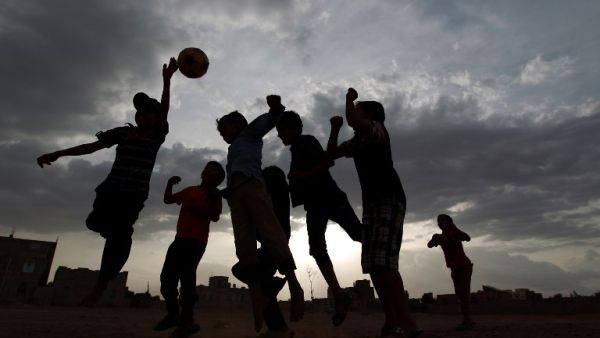 Yemeni children play football in a field in the capital Sanaa on June 10, 2014. AFP PHOTO/MOHAMMED HUWAIS
MOHAMMED HUWAIS / AFP