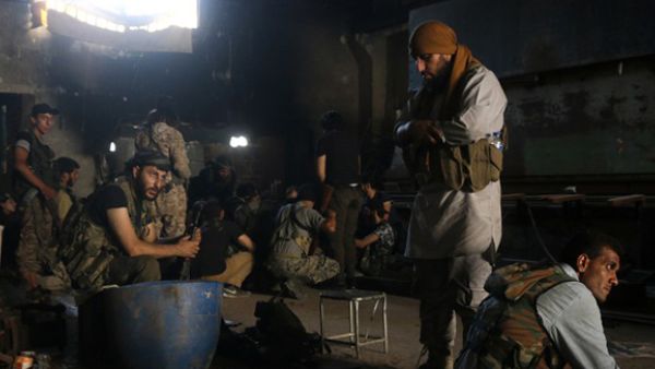 Fighters from the opposition forces pray and rest in a building as they battle in the Ramouse industrial neighbourhood on the southern outskirts of Aleppo in a bid to break the government siege on the northern Syrian city. (AFP/File)