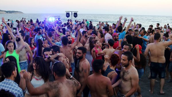 Syrians dance during a party at the Wadi Qandeel beach (Jellyfish Valley) in the coastal city of Latakia. (AFP/File)