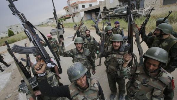 Syrian troops celebrate as they take control of the village of Haydariyah, some seven kilometers outside the rebel-held town of Qusayr (AFP/ Joseph Eid)