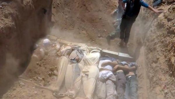 SYRIA, DAMASCUS : An image grab taken from a video uploaded on YouTube by the Local Committee of Arbeen on August 21, 2013 allegedly shows Syrians covering a mass grave containing bodies of victims that Syrian rebels claim were killed in a toxic gas attack by pro-government forces in eastern Ghouta and Zamalka, on the outskirts of Damascus. AFP PHOTO / YOUTUBE / LOCAL COMMITTEE OF ARBEEN SYRIA, DAMASCUS : An image grab taken from a video uploaded on YouTube by the Local Committee of Arbeen on August 21, 2013 allegedly shows Syrians covering a mass grave containing bodies of victims that Syrian rebels claim were killed in a toxic gas attack by pro-government forces in eastern Ghouta and Zamalka, on the outskirts of Damascus. AFP PHOTO / YOUTUBE / LOCAL COMMITTEE OF ARBEEN