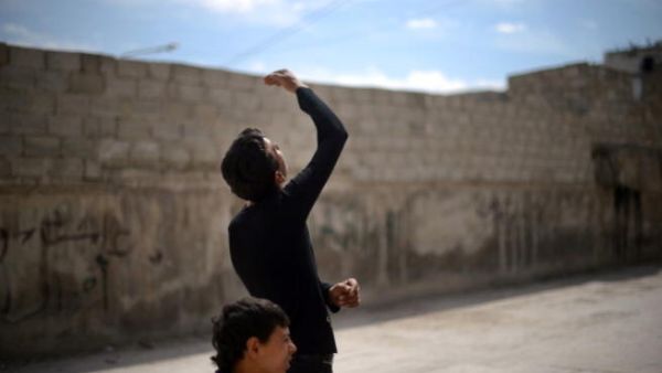 A Syrian young man looks up as a government forces fighter jet flies overhead in the northern Syrian city of Aleppo on April 15, 2013. ( DIMITAR DILKOFF/AFP/Getty Images) A Syrian young man looks up as a government forces fighter jet flies overhead in the northern Syrian city of Aleppo on April 15, 2013. ( DIMITAR DILKOFF/AFP/Getty Images)